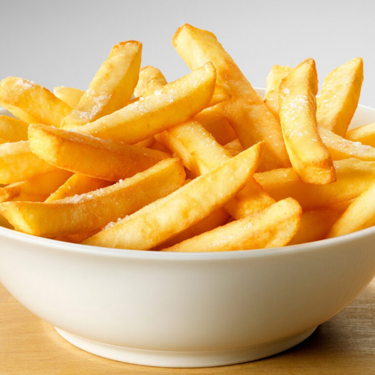 Salted French fries in white bowl on a wooden tray